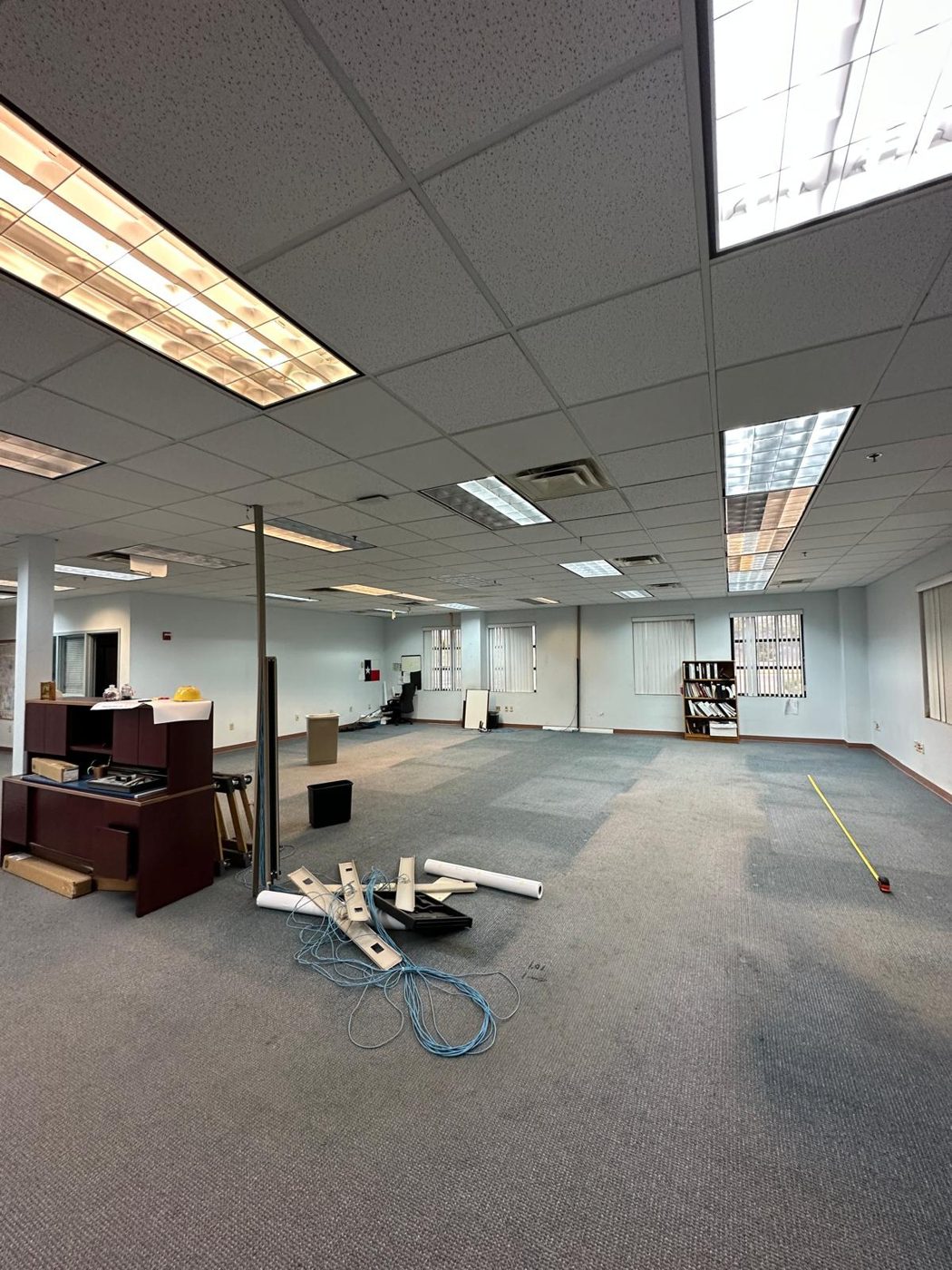 HR office before remodel, dated carpet and cluttered layout